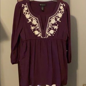 Maroon top with cream detail around the neck top
